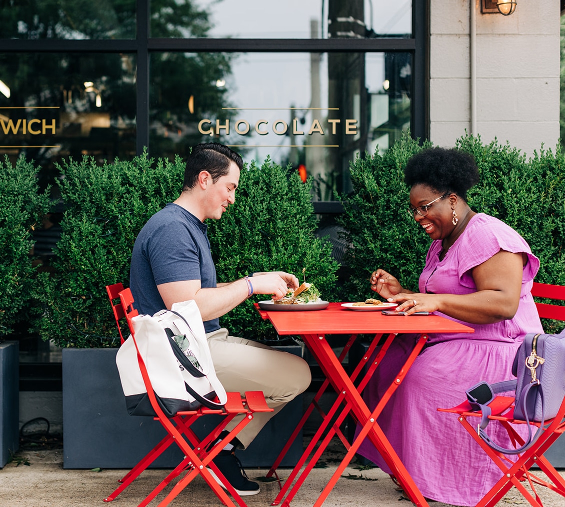 two people eating outside coffee shop